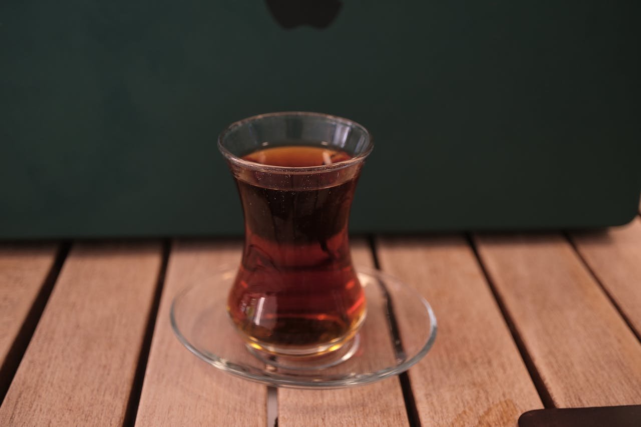 Traditional Turkish tea in tulip glass on a wooden table in Bornova, Izmir.